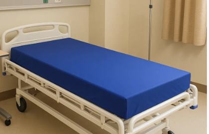 Navy hospital mattress fitted on a ward bed